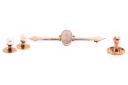 An opal bar brooch and three dress studs; the brooch set with a central oval cabochon of precious op