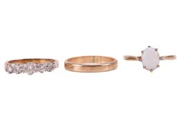 A group of three 9ct rings; including a five-stone diamond ring, set with a central oval cut diamond