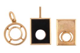 A group of pendant mounts; the first a round pendant mount (stone deficient) with an oval suspension