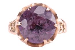 A synthetic colour-change sapphire dress ring, featuring a circular-cut colour-change sapphire of 12