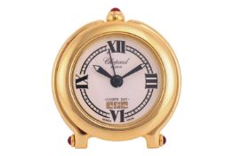 Chopard - a gilt metal 'Happy Day' travel alarm clock, with a white enamel face with Roman numerals 