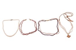 Four beaded necklaces, including a cultured pearl and cord necklace leading to a ruby and pearl-set 