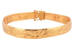 A bangle engraved with foliate design, the 8.1mm bangle featuring foliate and scroll engraving, comp