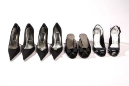 Stuart Weitzman - a pair of bow open-toe mules in black patent leather; a pair of mules with acrylic
