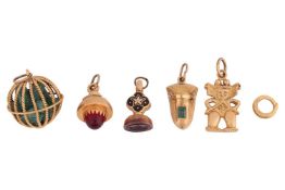 A collection of five charms; to include a sphere composed of twisted cables, caging multiple emerald