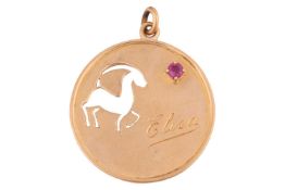A gazelle pendant, of circular form, pierced with a gazelle and engraved with the name 'Elisa', claw