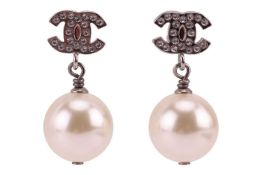 Chanel - a pair of drop earrings with CC logo set with paste, suspending a round faux pearl drop, si