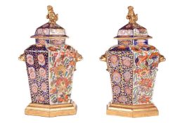 A pair of large Masons-style Ironstone hexagonal vases, in the Imari palette, with domed covers and 