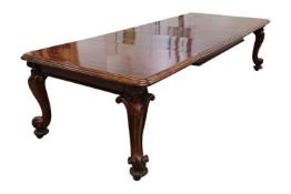 A fine Victorian figured 'Fiddle' mahogany extending dining table c.1860, with moulded top and windi