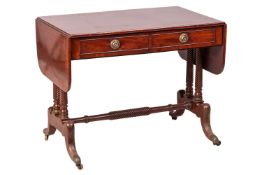 A George IV mahogany two-flap sofa table with ebony strung and crossbanded top fitted with two real 