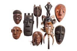 Eight African masks, including songye and Guro and others.