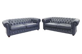 A pair of contemporary blue/grey leather upholstered Chesterfield style two-seater sofas, 70 cm high