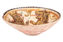 A Persian Nishapur style circular pottery bowl, painted in earth pigments of a slip-covered ground, 