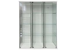 Three glazed narrow four-glass display cabinets, each with three glass shelves, 162 cm high x 42.5 c