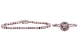 A diamond halo ring together with a diamond line bracelet; the ring in 9ct white gold centred with a