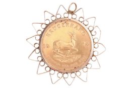 A Krugerrand in a 9ct gold pendant mount, comprising a 1974 1oz Krugerrand, in a detachable surround