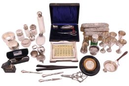 A collection of silver, to include a silver mounted perpetual calendar, a tea strainer and stand, a 