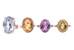 A collection of four gem-set rings; to include a 9ct gold peridot ring in size J, a 9ct gold synthet