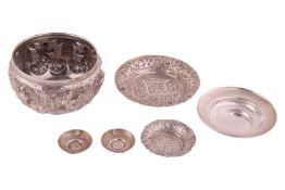 A 20th-century Thai or Burmese silver circular finger bowl, heavily embossed with dancers in the rou