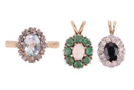 An aquamarine halo ring and two gem-set pendants; the ring centred with an oval-cut aquamarine of 7.