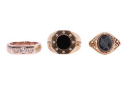 Three gents rings; comprising a hematite intaglio ring, in a 9ct gold mount, size V, 2.9 grams, a he