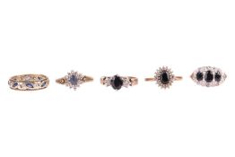 A group of five gem-set rings; The first a sapphire and paste ring in 9ct gold, featuring eight marq