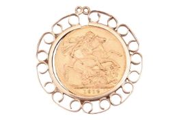 A George V 1912 full sovereign, in a 9ct gold detachable pendant mount with scrolling border, 3.2 cm