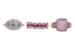 A group of three gem-set rings; The first an emerald and diamond cluster ring, comprising three roun