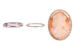 A shell cameo brooch in twisted rope surround, yellow metal marked '9ct'; a wedding band in size L½ 