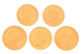 A collection of five Austrian gold coins, including a 1892 twenty-franc coin, 1915, a twenty corona 