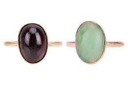 A pair of cabochon rings; to include an oval garnet cabochon dress ring in yellow metal stamped '18c