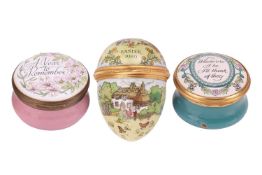 A collection of three patch boxes; one in the form of an egg, depicting a rural scene, measuring 6.0