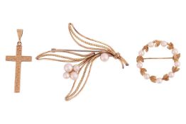 A pendant and two brooches; to include a 9ct gold cross pendant engraved with foliate patterns, a 9c