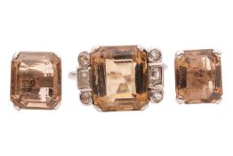 A smoky quartz ring and a pair of matching earrings; the ring claw-set with a large step-cut smoky q