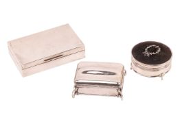 Three silver boxes; an Edwardian silver jewellery box, rounded rectangular with undulating cover, re