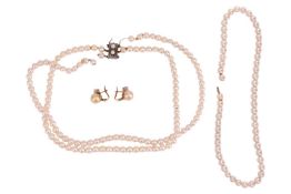 A three-row cultured pearl necklace, the uniform sized pearls to a rectangular clasp, marked 'silver