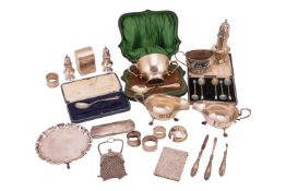 A good agglomeration of silver hollowware, including a sugar caster, pepperettes, a pair of gravy bo