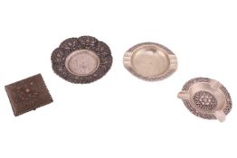 A group of Indonesian white metal, comprising an oval ashtray, a circular ashtray and a gem-set ciga
