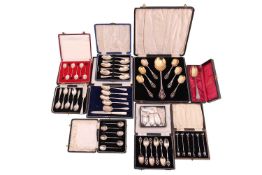 A cased set of dessert spoons, including a fruit serving spoon, with pierced handles and gilded bowl