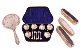 A cased set of six Victorian silver-plated cauldron-shaped salt cellars and five condiment spoons en
