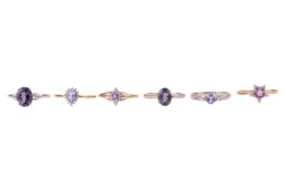 Six rings in 9ct gold set with purple gemstones; to include a star-cut amethyst solitaire in size S,