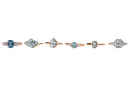 Six 9ct yellow gold dress rings set with pale blue gemstones; to include two blue zircon and diamond