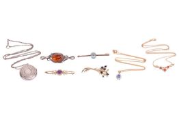 A small group of jewellery items, including a sapphire and diamond cluster pendant in a bi-colour me