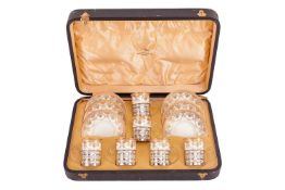 A cased and silver-mounted Wedgwood porcelain cabaret coffee set with pierced silver cup frames and 