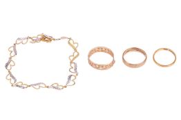 A small group of jewellery items comprising a bi-colour metal bracelet, the links of stylised heart 