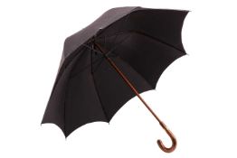 A Briggs London black umbrella with gilt metal collar signed Briggs, to a curved wooden handle. dama