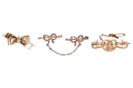 Three brooches; to include a Stafford knot bar brooch set wtih seed pearls, in yellow metal marked '