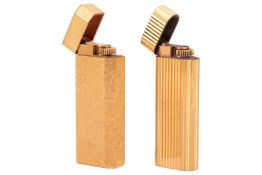 Cartier - two gold-plated lighters, one of grooved design, the other with crosshatch finish, signed 