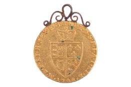 A George III, 1788 Gold Spade Guinea, with applied mount, 8.8 grams, 24 mm diameter.