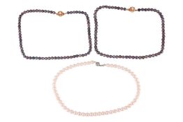 Three strands of cultured pearl necklaces; including two identical single-row black pearl necklaces 